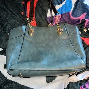 Women's tote/shoulder bag with a faux leather texture and gold-tone hardware.